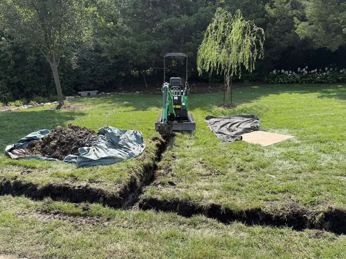 French drain trench across a large lawn